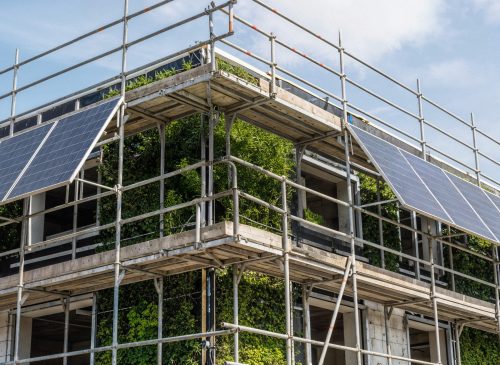 building-with-solar-panels-scaffolding