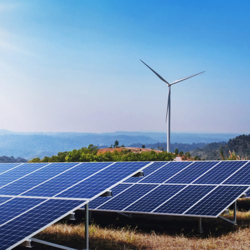 concept clean energy power in nature. solar panel and wind turbine on hill with sunshine