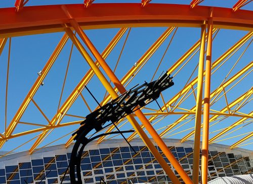low-angle-view-rollercoaster-against-clear-blue-sky