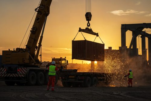 shipping-container-being-loaded-onto-truck-sunset