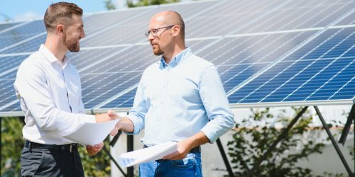 The solar farm(solar panel) with two engineers walk to check the operation of the system, Alternative energy to conserve the world's energy, Photovoltaic module idea for clean energy production.
