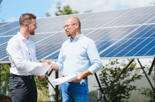 The solar farm(solar panel) with two engineers walk to check the operation of the system, Alternative energy to conserve the world's energy, Photovoltaic module idea for clean energy production.