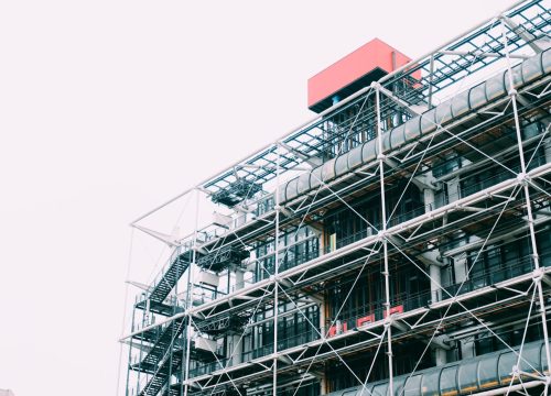 A vertical shot of a metal structure under the bright sky